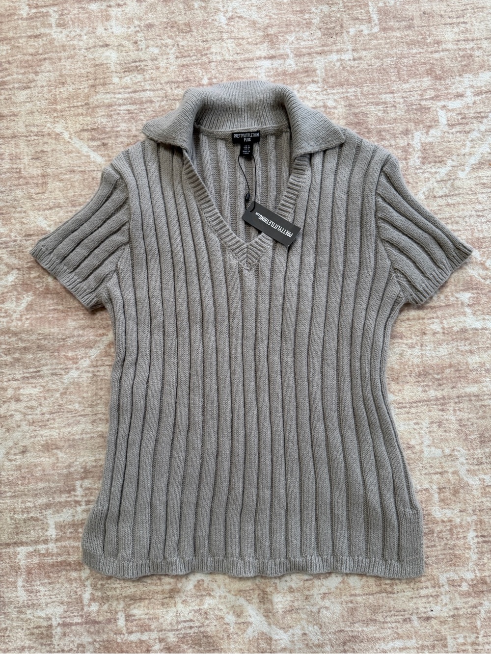 New gray knit sweater with short sleeves. Women’s US size 12.